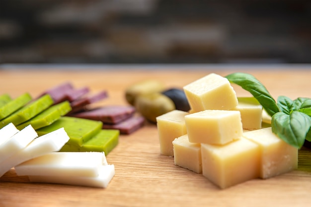 Cheese background. Assortment of different types of cheese on a wooden background.Place for text.