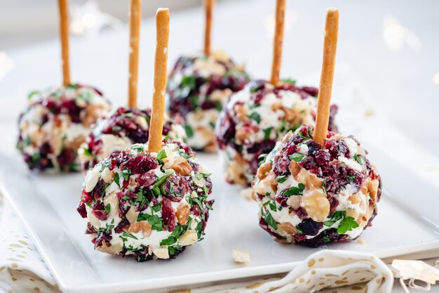 cheese ball appetizers with cranberries, pecans and herbs.