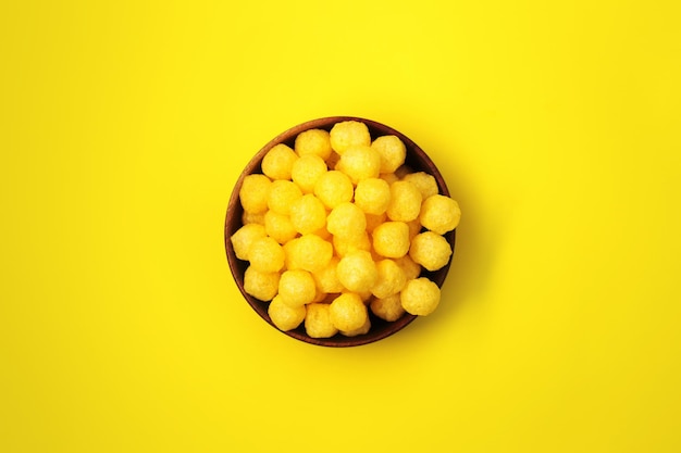 Cheese balls snacks in large quantities on a bright even background