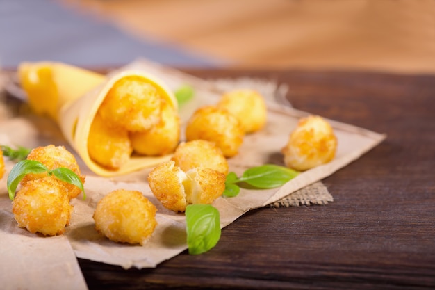 Cheese balls with basil leaves