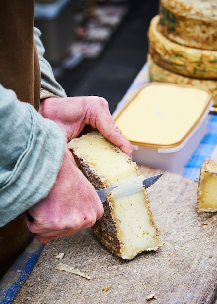 Cheese being cut into slices