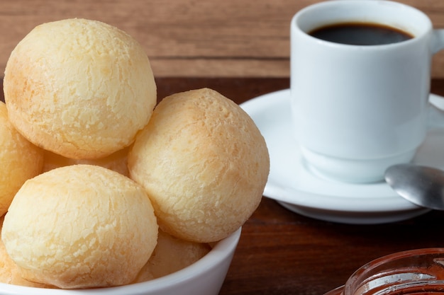 Cheese bread (pÃÂÃÂÃÂÃÂÃÂÃÂÃÂÃÂÃÂÃÂÃÂÃÂÃÂÃÂÃÂÃÂ£o de queijo) and a cup of coffee.