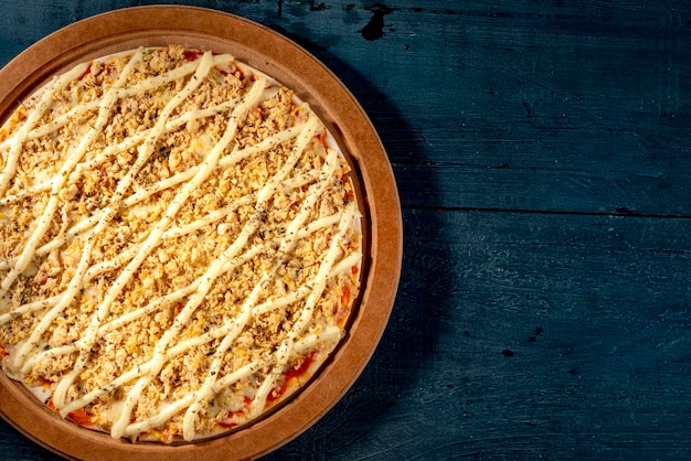 Cheese  catupiry  and chicken pizza on indigo blue wooden table space for text