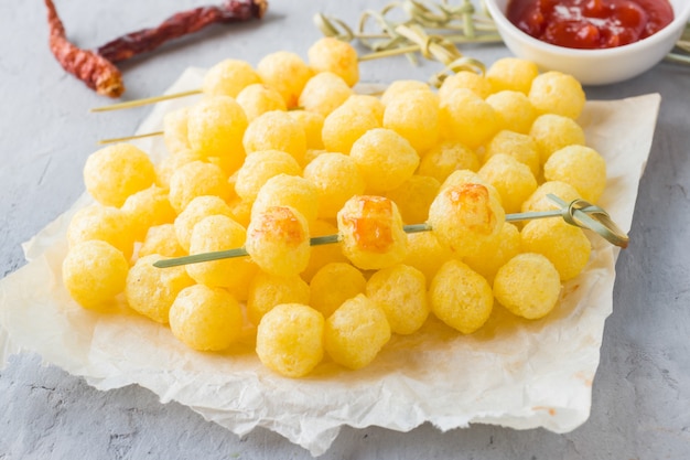 Cheese corn balls with spicy tomato sauce