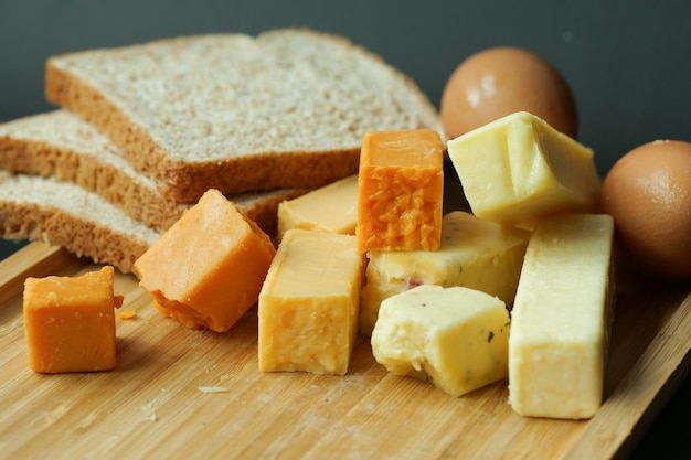 Cheese cubes green yellow and red color on chopping board