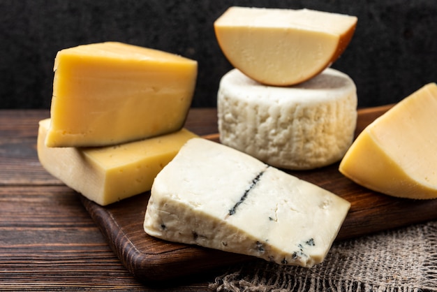 Cheese on dark wooden background.