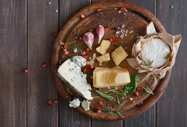 Cheese delikatessen closeup on rustic wood, blue roquefort and parmesan