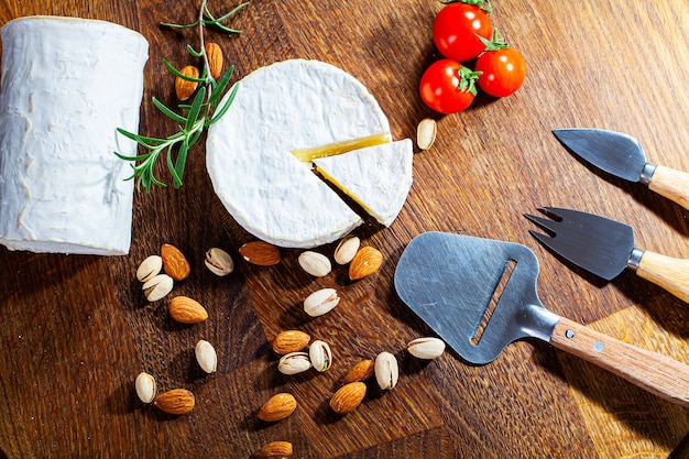 Cheese of elite variety sliced on a wooden board