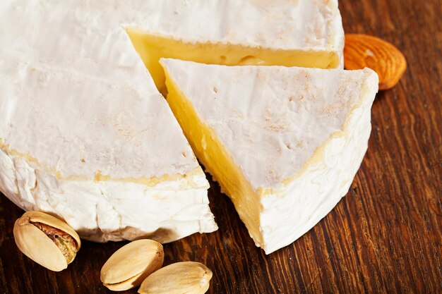 Cheese of elite variety sliced on a wooden board.