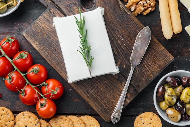 Cheese feta greek salad ingredients, on dark wooden table, flat lay