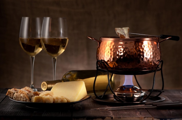 Cheese fondue on rustic background