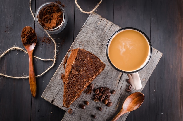 Cheese in ground coffee and a cup of cappuccino