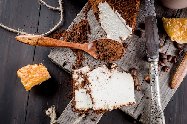 Cheese in ground coffee and a cup of cappuccino