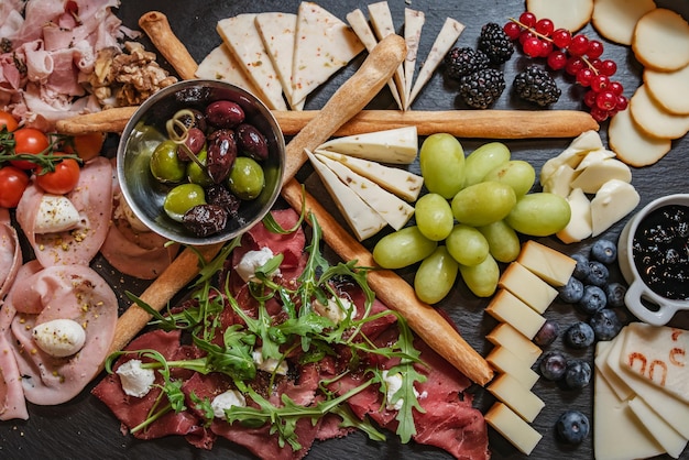 Cheese and meat platter with fruits