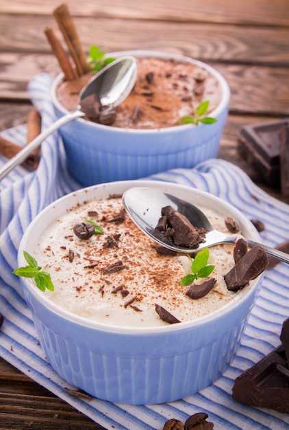 Cheese mousse with mint and cinnamon on wooden table. Desert