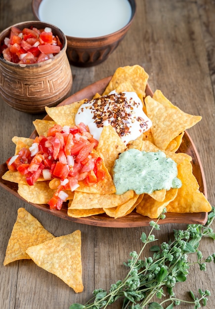 Cheese nachos with different types of sauce