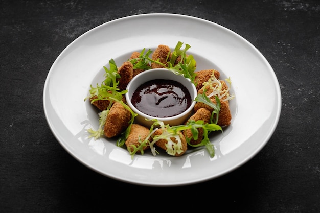 Cheese nuggets with sauce on a plate