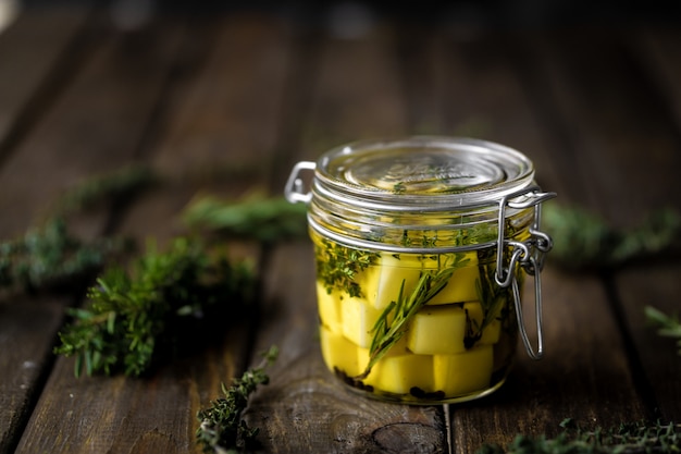 Photo cheese in olive oil with aromatic herbs (thyme and rosemary).