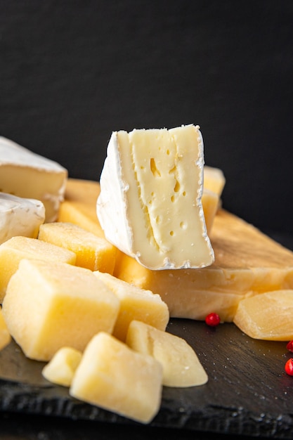 cheese plate assorted types of cheese brie camembert parmesan cheddar and others healthy meal