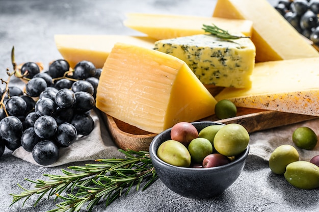 Cheese plate served with grapes, crackers, olives and nuts.