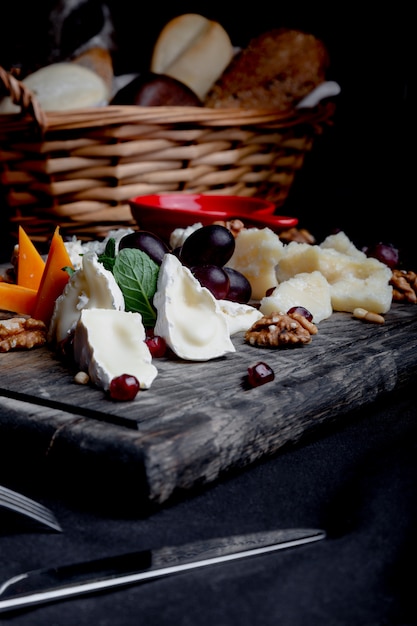 Cheese plate served with grapes, honey and nuts