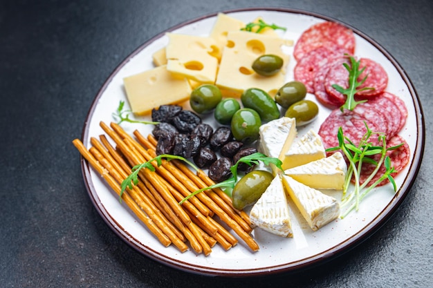 cheese plate snack sausage olive bread stick fresh appetizer meal food snack on the table