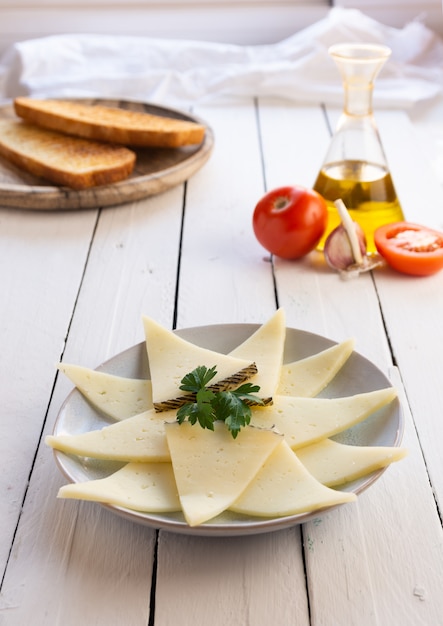 Cheese plate on white wooden table