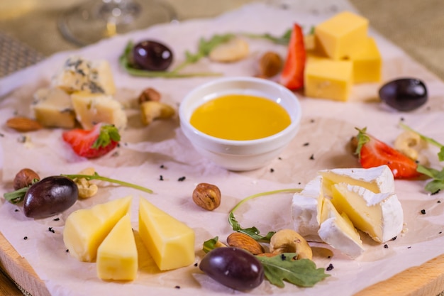 Cheese plate with cheeses dorblu parmesan brie camembert and roquefort in serving on the table from ...