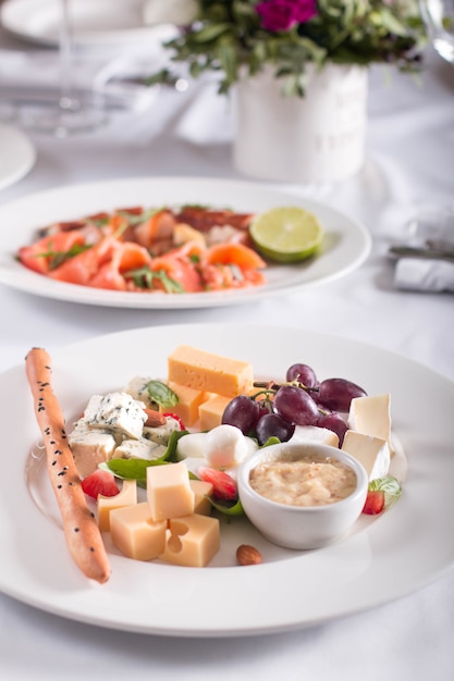 Cheese plate with fruit on the banquet table