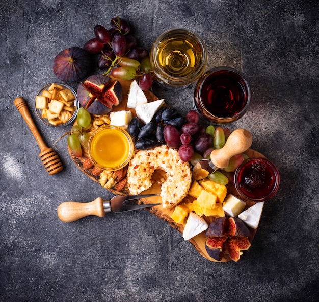 Cheese plate with grapes and wine