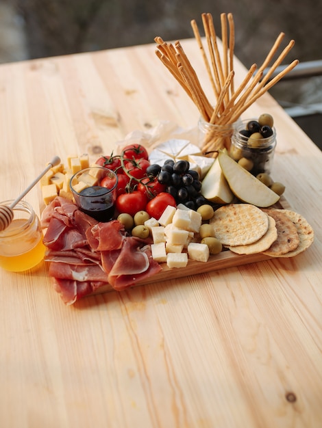 Cheese plate with prosciutto and vegetables