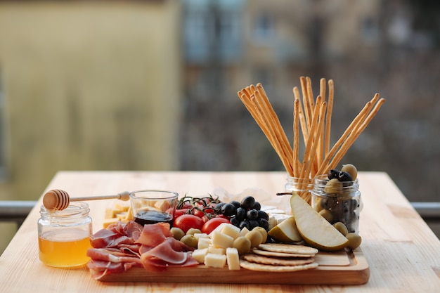 Cheese plate with prosciutto and vegetables