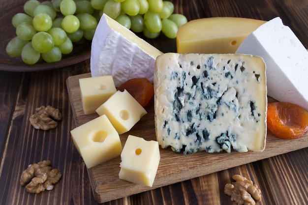 Cheese plate on the wooden cutting board