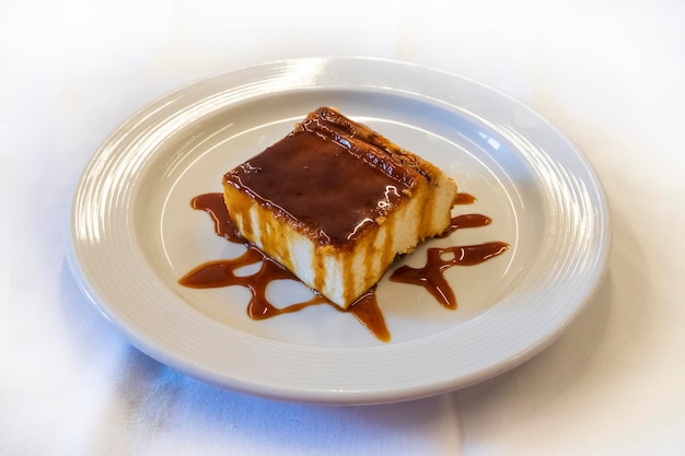 Cheese ramekin or quesada or cheesecake with icecream and chocolate coating on the dish