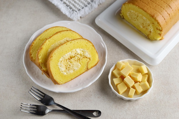 Cheese roll cake served on white plate