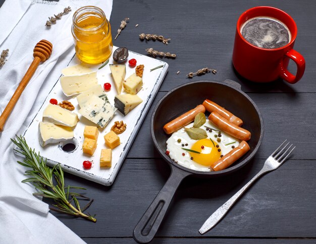 Photo cheese and a round cast-iron frying pan with fried egg