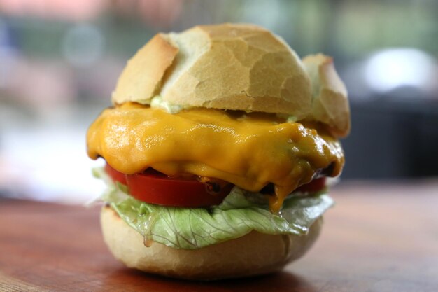 Cheese salad burger on a wooden background