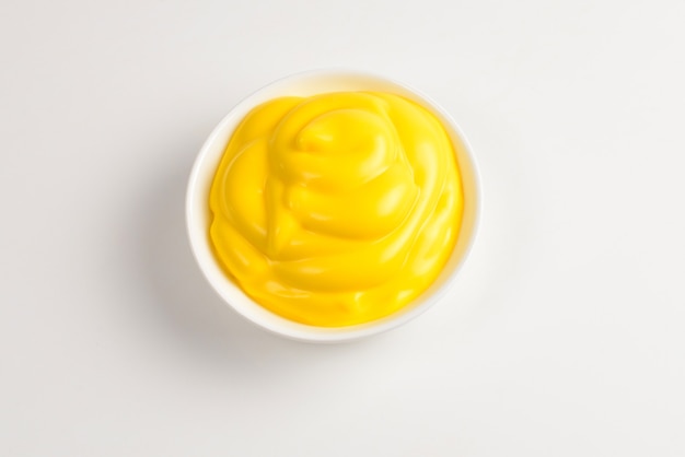 Cheese sauce in white plate on white background