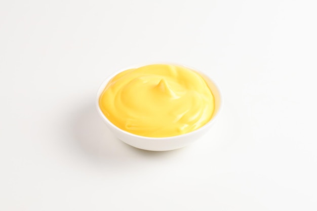 Foto salsa di formaggio in piatto bianco su fondo bianco