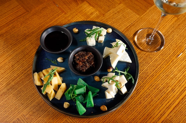 Cheese set on black palet with souse