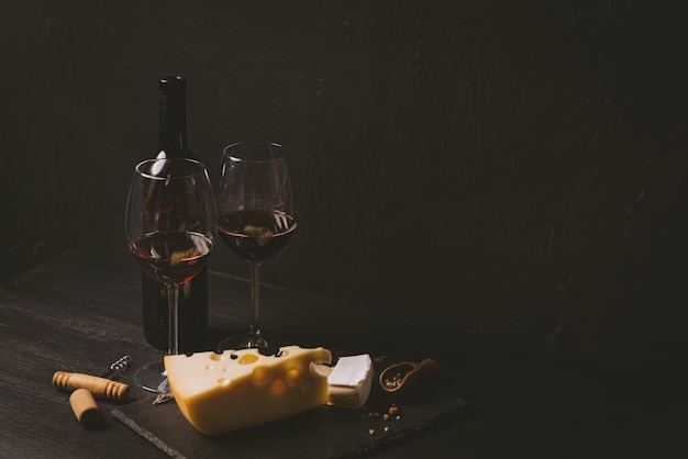 Cheese slices and glass wine on the table