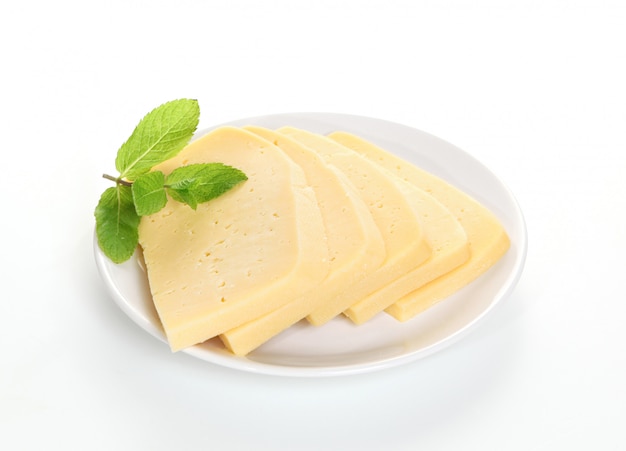 Cheese slices on a plate with leaves