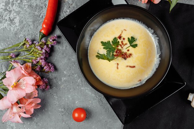 Cheese soup in a black plate