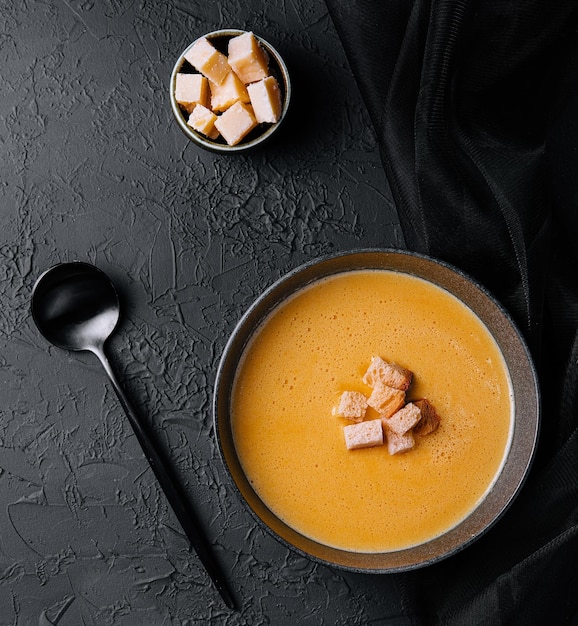 Cheese soup with crackers top view