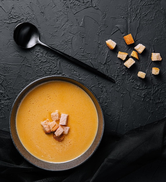 Cheese soup with crackers top view