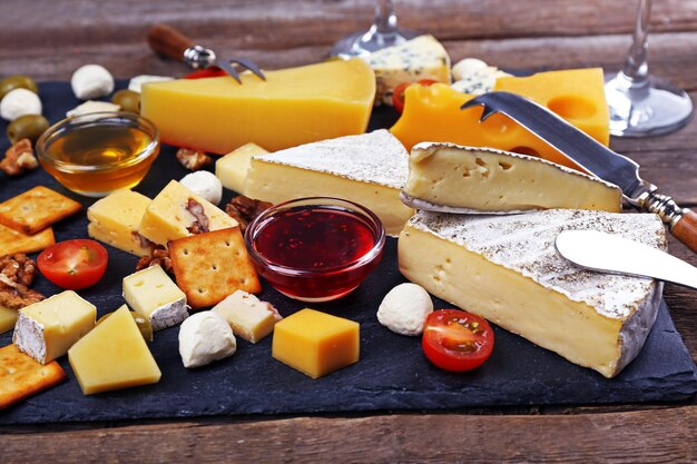 Cheese for tasting on wooden table closeup