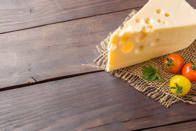 Cheese and tomatoes on wood