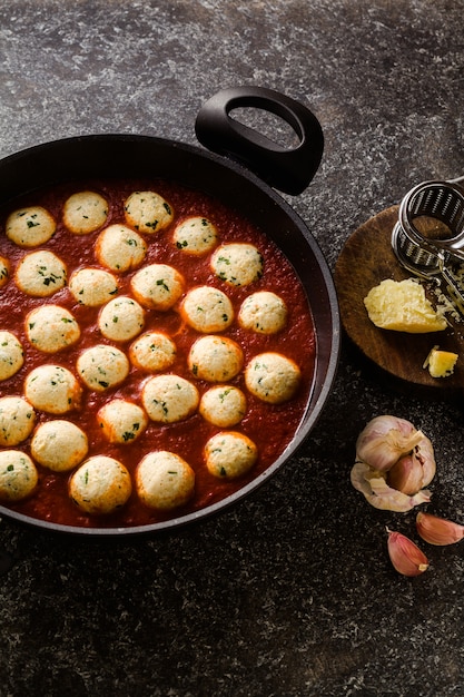 Cheese veggie ricotta meatballs in tomato sauce in a pan. traditional Italian cuisine for the whole family, party or restaurant menu