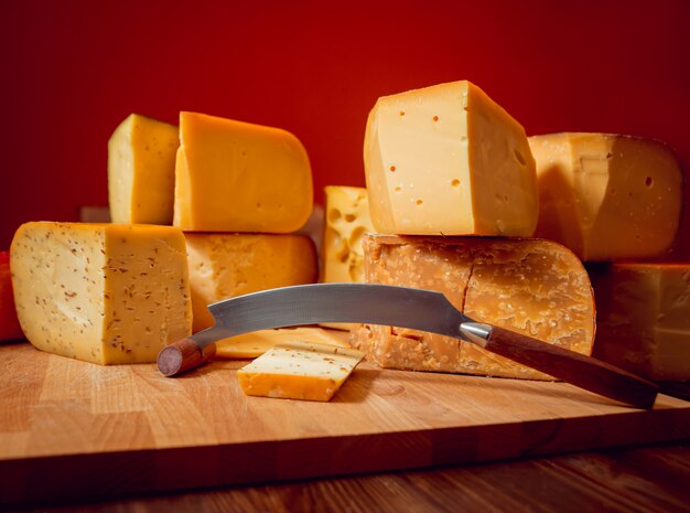 Cheese and wine on a dark table.