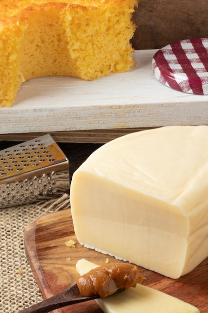 Cheese with dulce de leche on cutting board